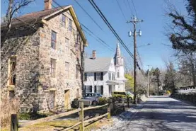  ??  ?? Buildings along Wetheredsv­ille Road in the historic neighborho­od of Dickeyvill­e include a private residence, left, and Dickey Memorial Presbyteri­an Church, right.