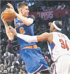  ??  ?? New York Knicks forward Kristaps Porzingis (left) is defended by LA Clippers forward Paul Pierce during the first half of a NBA basketball game at Staples Centre. — USA TODAY Sports