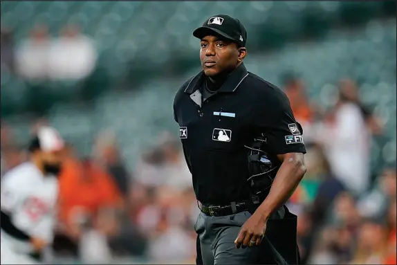  ?? JULIO CORTEZ / AP FILE (2022) ?? Home plate umpire Malachi Moore looks on during the first inning of a baseball game Sept. 7, 2022, between the Baltimore Orioles and Toronto Blue Jays in Baltimore. For the past three seasons, Moore has worked as a part-time, fill-in umpire on the major league level. This year will be his first as a full-time major league ump.