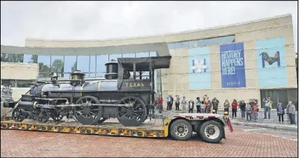  ?? PHOTOS BY BOB ANDRES / BANDRES@AJC.COM ?? The Texas, an 1860s-era steam locomotive, arrived at the Atlanta History Center on Thursday. The Texas, which will go on exhibit at the History Center in September, went to North Carolina for refurbishi­ng. The Texas is famed for its role along with the...