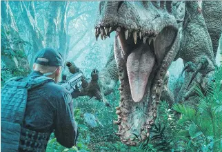  ?? CHUCK ZLOTNICK/UNIVERSAL PICTURES ?? Indominus rex pops out of the jungle foliage in one of the frequent scares that make a movie like Jurassic World worth seeing.