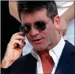  ??  ?? HANGING UP: TV mogul Simon Cowell on his phone