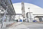  ?? Sergei Supinsky / AFP / Getty Images ?? The dome encasing the destroyed reactor is said to be the world’s largest movable metal structure.