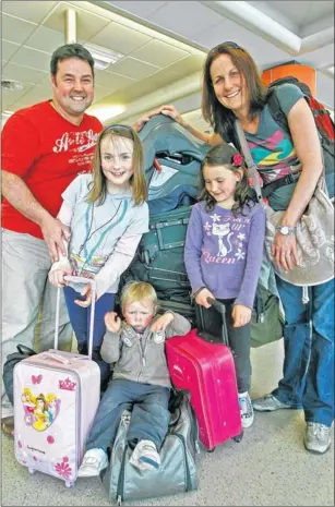  ??  ?? PAYING UP: The Collins family from Perth depart Edinburgh for a South African break.