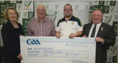  ??  ?? Kathy Slattery and Jim Bolger (presenting a Leinster GAA Club Developmen­t Grant cheque for €17,500 awarded to Kilmacanog­ue GAA Club represente­d by from left Des Fox and Des Fox, Jun.