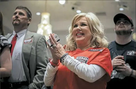  ?? Audra Melton/The New York Times ?? Supporters of Secretary of State Brian Kemp, the Republican candidate for governor, monitor election results at an Election Night gathering in Athens, Ga.