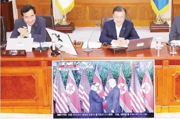  ??  ?? Moon (right) and South Korean Prime Minister Lee Nak-yon (left) watch a television screen showing the summit between Trump and Kim during a Cabinet meeting at the presidenti­al Blue House in Seoul. — AFP photo