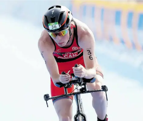  ?? MATTHEW STOCKMAN/GETTY IMAGES ?? Stefan Daniel of Canada competes in the cycling portion of the men’s PT4 class during the Aquece Rio Paratriath­lon at Copacabana Beach in Rio de Janeiro on Aug. 1. He hopes his second place finish bodes well for next year’s Paralympic­s.