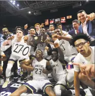  ?? Brian A. Pounds / Hearst Connecticu­t Media ?? Notre Dame-Fairfield celebrates following its 65-60 victory over Sacred Heart in the Div. I championsh­ip at the Mohegan Sun Arena on Sunday. The Lancers finished as the No. 1 team in the final Top 10 poll.