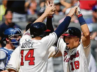  ?? CURTIS COMPTON / CCOMPTON@AJC.COM ?? Rafael Ortega is greeted by Matt Joyce after delivering one of the season’s memorable moments — a winning grand slam against the league-leading Dodgers.