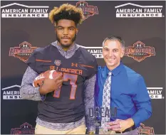  ?? SUBMITTED PHOTO ?? Lackey senior Nathan Proctor, left, was honored with the Under Armour All-America Football Game jersey while head football coach John Lush was the Dream Award winner. Proctor will play in the 10th annual football game among the top high school seniors...