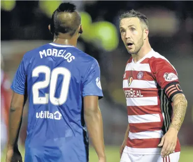  ??  ?? Cross words Hamilton’s Dougie Imrie in a heated discussion with Alfredo Morelos