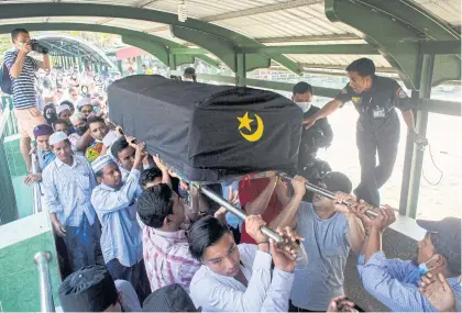  ??  ?? People attend a funeral of U Khin Maung Latt, 58, an NLD ward chairman in Yangon yesterday. REUTERS