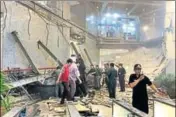  ??  ?? Security officials stand near rubble inside the Indonesia Stock Exchange tower in Jakarta on Monday.