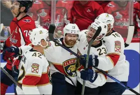  ?? ALEX BRANDON - THE ASSOCIATED PRESS ?? Florida Panthers defenseman Gustav Forsling, right wing Claude Giroux, center Carter Verhaeghe and center Aleksander Barkov, from left, celebrate Giroux’s goal against the Washington Capitals during the third period of Game 6of a first-round NHL hockey Stanley Cup playoff series Friday, May 13, 2022, in Washington.