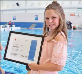  ?? STEVE MacNAULL/The Daily Courier ?? Alexis Edall, 10, of Kelowna was honoured Wednesday in a ceremony on the pool deck at the H2O Adventure + Fitness Centre for saving the life of a toddler who fell into a backyard pool earlier this month.