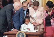  ?? ANNA MONEYMAKER/GETTY IMAGES ?? Gianna Floyd, the daughter of George Floyd, sits at President Joe Biden’s desk after Biden signed an executive order enacting further police reform on Thursday in the East Room of the White House.