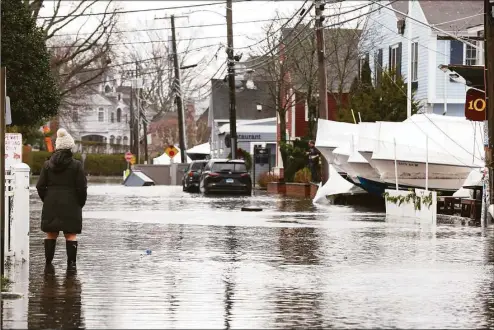  ?? Patrick Sikes / For Hearst Connecticu­t ?? Flood waters rise in Rowayton on Friday. A storm battered the area Friday, flooding roads and leaving tens of thousands without power.