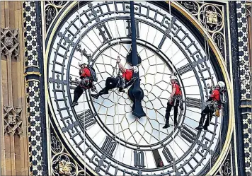  ?? PICTURE: ANDY RAIN / EPA ?? DON’T WASTE IT: Men abseil from the landmark Big Ben in London. The writer says that by advancing our clocks will put South Africa in sync with the rest of the world.