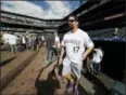  ?? DAVID ZALUBOWSKI — THE ASSOCIATED PRESS FILE ?? In this file photo, retired Colorado Rockies first baseman Todd Helton (17) steps out of the dugout as members of the Rockies’ 2007 Word Series team look on during batting practice before the Rockies host the San Diego Padres in a baseball game in...