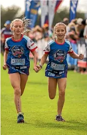  ?? DAVID UNWIN/FAIRFAX NZ ?? Lucy Summerfiel­d and Miela Slight finish the WeetBix Tryathlon.