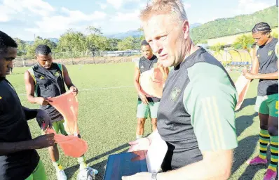  ?? RUDOLPH BROWN ?? Reggae Boyz head coach Heimir Hallgrimms­on speaks with Reggae Boy hopefuls on the first day of a training camp at the UWI-JFF Captain Horace Burrell Centre of Excellence yesterday.