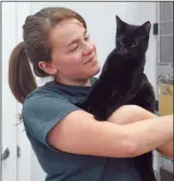  ?? NEWS PHOTO CHARLES LEFEBVRE ?? Kaylee Getz, animal services manager at Alberta Pound and Rescue Centre, holds up Julian, a cat waiting to be adopted with his brother Ricky, at the shelter on Monday. APARC is reminding Hatters that, while a pet may seem like a good idea for a...