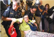  ?? DOUG MILLS/THE NEW YORK TIMES ?? A demonstrat­or is removed from outside of the offices of Senate Majority Leader Mitch McConnell Thursday on Capitol Hill as several gathered to protest Medicaid cuts.