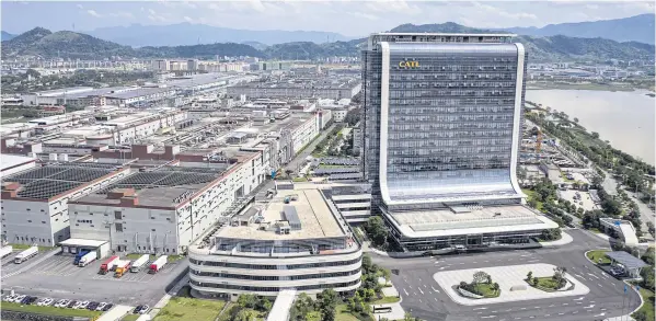  ?? PHOTOS BY BLOOMBERG ?? Contempora­ry Amperex Technology Co’s headquarte­rs building, right, and production facilities stand in this aerial photograph taken in Ningde, Fujian province.