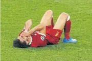  ??  ?? Liverpool’s Mohamed Salah reacts after sustaining an injury against Real Madrid.