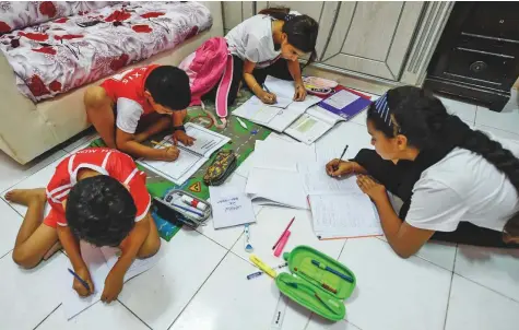  ?? Ahmed Ramzan/Gulf News ?? Children doing homework at home in Sharjah. Indian schools have a vast syllabus to cover each year and schools use homework, which carries marks, as a way of completing the syllabus. Picture for illustrati­ve purposes.