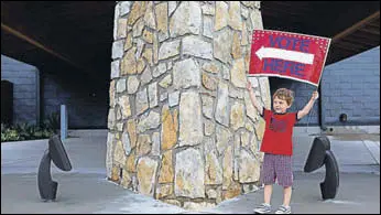  ?? NYT ?? Harrison Shaffer, 3, plays with a "vote here" sign at the Johnson County Museum in Kansas.