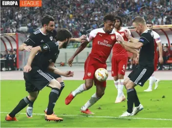  ?? AP ?? Alex Iwobi ( centre) of Arsenal duels for the ball with Qarabag’s Maksim Medvedev ( right) during their Group ‘ E’ Europa League match at the Olympic stadium in Baku, Azerbaijan on Thursday. Arsenal won 3- 0. —