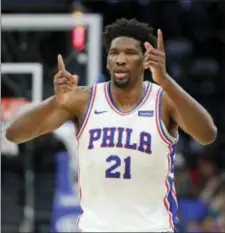  ?? JOHN RAOUX — THE ASSOCIATED PRESS ?? 76ers’ Joel Embiid (21) gestures with his hands after making a shot and drawing a foul during the first half of a game against the Orlando Magic on Thursday.