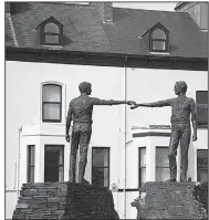  ?? Rick Steves’ Europe/DOMINIC ARIZONA BONUCCELLI ?? The sculpture Hands Across the Divide epitomizes Derry’s hopes for a peaceful future.