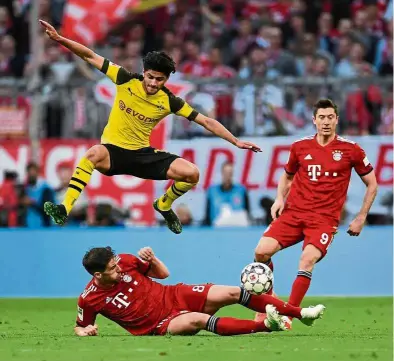  ?? — Reuters ?? Threat neutralise­d: Bayern Munich’s Javi Martinez tackling Borussia Dortmund’s Mahmoud Dahoud during the Bundesliga match at the Allianz Arena on Saturday.