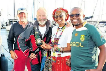  ??  ?? World ARC sailors Simon Ashworth and Donald Begg are welcomed to Zululand Yacht Club by Hlengiwe Ntanzi (ZYC and uMhlathuze Community Tourism Organisati­on representa­tive) and Tata Mncedisi Hlalatu (Ocean Cruising Club Port Officer)