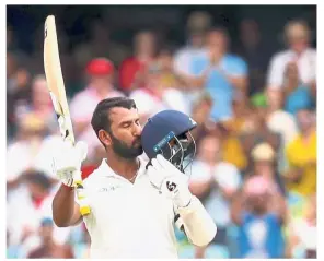  ??  ?? Jubilant: India’s Cheteshwar Pujara kisses his helmet after reaching his century (100 runs) during the first day of the fourth and final cricket Test against Australia at the Sydney Cricket Ground in Sydney yesterday. — AFP