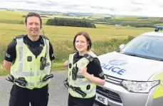  ??  ?? PC Alasdair MacHardy and Sergeant Lorraine Mackie on patrol in the Formartine area, Aberdeensh­ire.