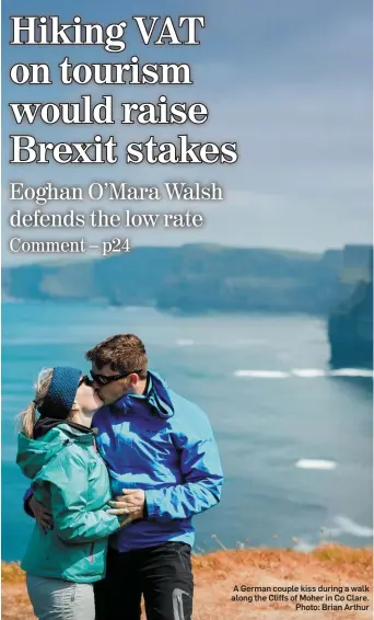  ??  ?? A German couple kiss during a walk along the Cliffs of Moher in Co Clare. Photo: Brian Arthur