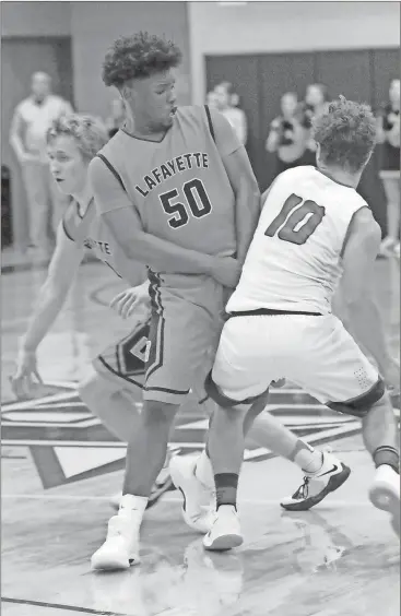  ??  ?? LaFayette’s Alex Kelehear (left) gets a screen from Dee Southern against Heritage’s Luke Grant during last Tuesday’s matchup in Boynton. The Ramblers picked up a 69-56 victory to remain the only unbeaten team in Region 6-AAAA. (Photo by Scott Herpst)