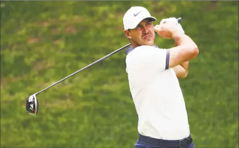  ?? Tim Bradbury / Getty Images ?? Brooks Koepka hits a tee shot during last year’s Travelers Championsh­ip at TRC River Highlands in Cromwell. Koepka, the No. 3 golfer in the world and a four-time major champion, will play in the event again next month.