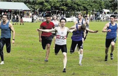  ??  ?? The 90-metre race was won by David Irvine, number 235, who sprints towards the finishing tape