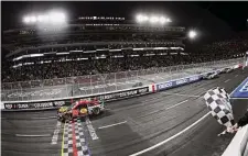  ?? Meg Oliphant/Getty Images ?? Martin Truex Jr., in the No. 19 Bass Pro Shops Toyota, takes the checkered flag to win the Clash at the Coliseum in Los Angeles.