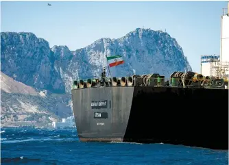  ?? AP-Yonhap ?? The renamed Adrian Aryra 1 super tanker hoisting an Iranian flag sails in the waters in the British territory of Gibraltar, Sunday. Authoritie­s in Gibraltar rejected the United States’ latest request not to release a seized Iranian supertanke­r, clearing the way for the vessel to set sail after being detained last month for allegedly attempting to breach European Union sanctions on Syria.