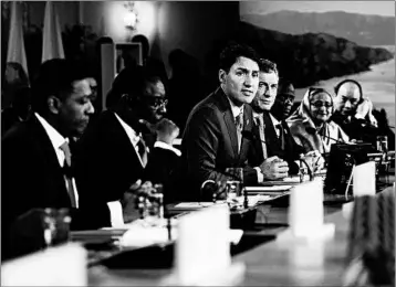  ?? SEAN KILPATRICK/ASSOCIATED PRESS ?? Canadian Prime Minister Justin Trudeau, center, participat­es in a working session during the G-7 summit Saturday. At the summit’s close, his remarks angered President Trump.