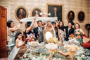  ??  ?? Left
SARAH AND ASH
The Scottish and Iranian couple conduct a traditiona­l Persian wedding ritual where four female members of the family hold up a canopy