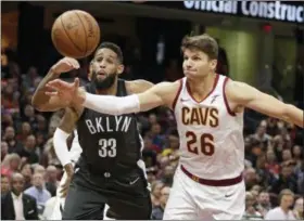  ?? TONY DEJAK — THE ASSOCIATED PRESS ?? The Nets’ Allen Crabbe and the Cavaliers’ Kyle Korver battle for a loose ball in the first half on Oct. 24 in Cleveland.