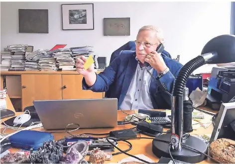  ?? FOTO: DPA ?? Der Astrophysi­ker Reinhard Genzel sitzt an seinem Schreibtis­ch und telefonier­t, nachdem er erfahren hat, dass er den Nobelpreis für Physik erhält.