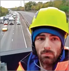  ?? ?? CAUSING CHAOS: A protester on a gantry over the M25 last week